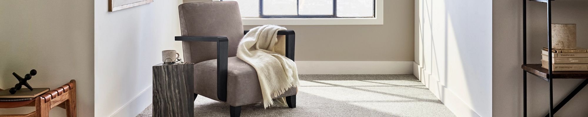 Gray armchair near window in a room with gray carpet from Choo Choo Carpets & Floor Coverings, Inc in Chattanooga, TN